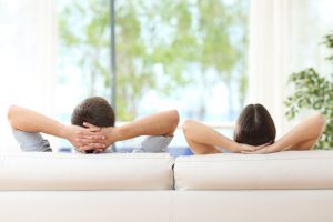 couple-satisfied-with-temperature-recline-on-white-couch